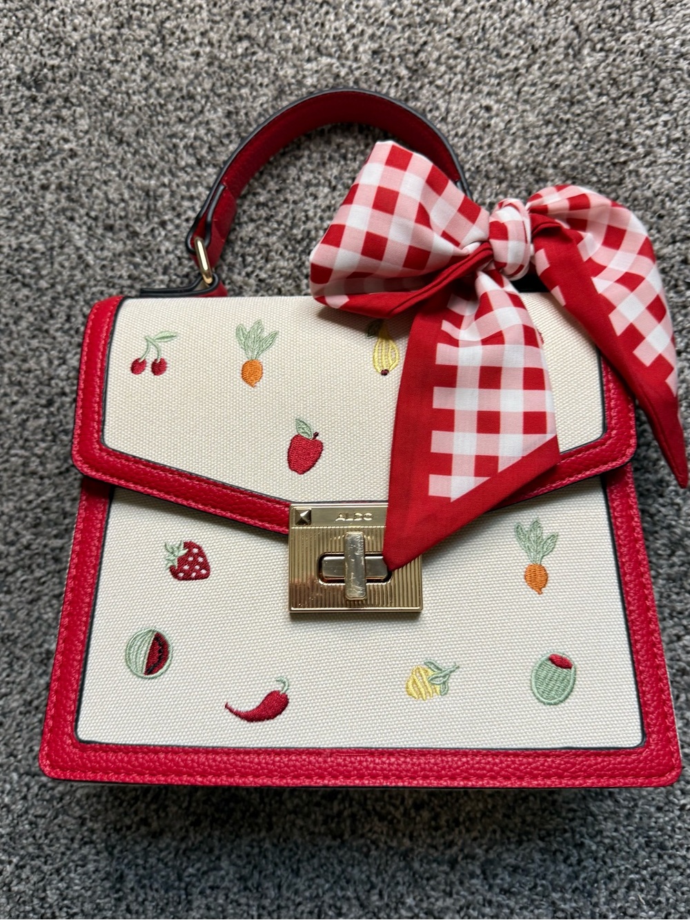 Aldo Cream and Red Fruit-Embroidered Top Handle Bag with Red Gingham Bow.